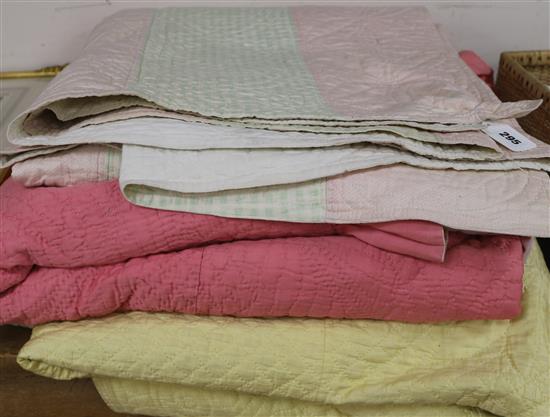 A rose pink and light pink reversible quilt, another reversible with yellow, the other mint green gingham and pink (3)